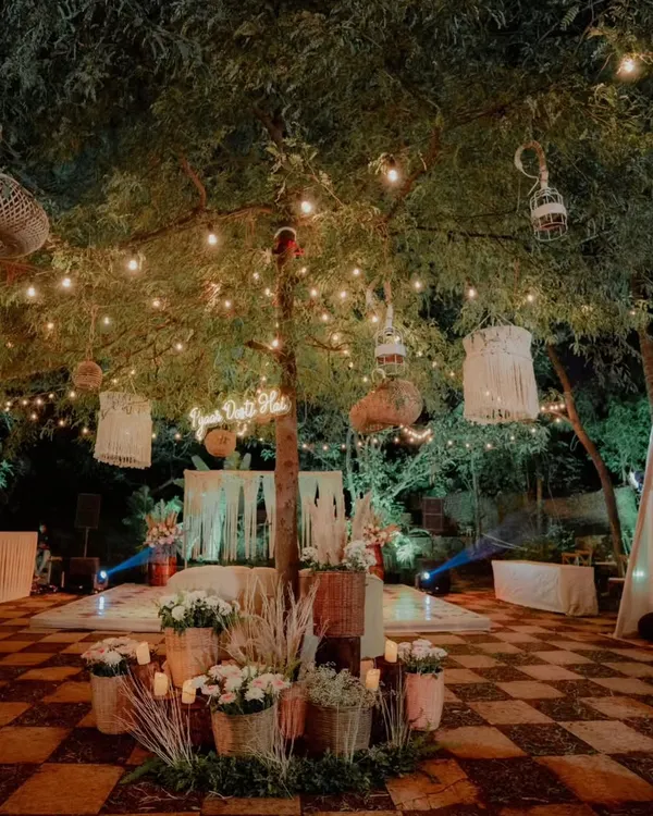 For this engagement party, I created a bohemian-chic vibe with rustic decor elements. The space featured macrame hangings, wicker lanterns, and a cozy tent, all illuminated by warm string lights to create a relaxed and romantic atmosphere.