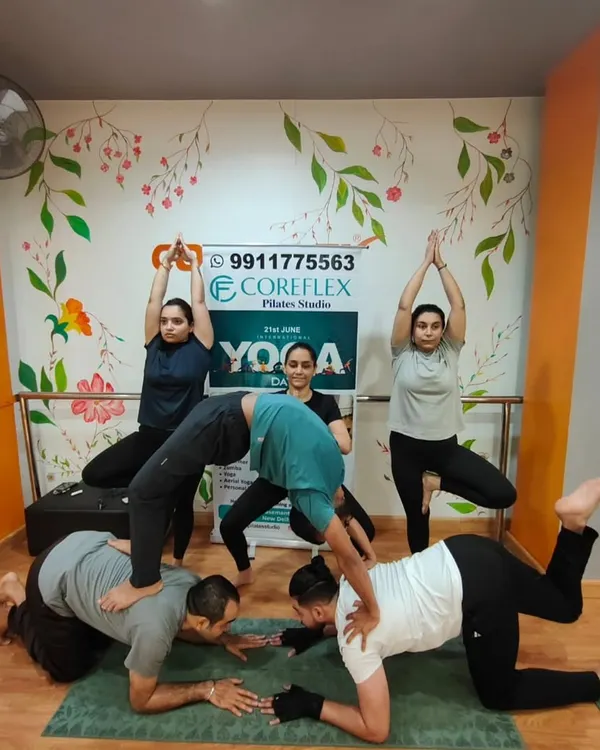 This is yoga as a team sport. Our group poses are a fun challenge that requires communication, trust, and a shared sense of balance, creating a strong bond between our members.