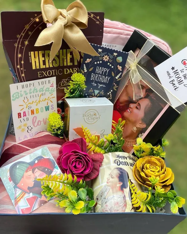 This luxurious birthday hamper for a client's wife is filled with personal touches. It includes a custom photo mug, a stylish scarf, premium Hershey's dark chocolate, Body Cupid perfume, and multiple heartfelt birthday cards, all arranged beautifully in a keepsake box.