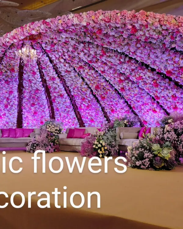We create immersive floral experiences that become the centerpiece of your celebration. This magnificent domed stage, covered entirely in thousands of pink and purple flowers, is designed to make your wedding day feel like a fairytale.