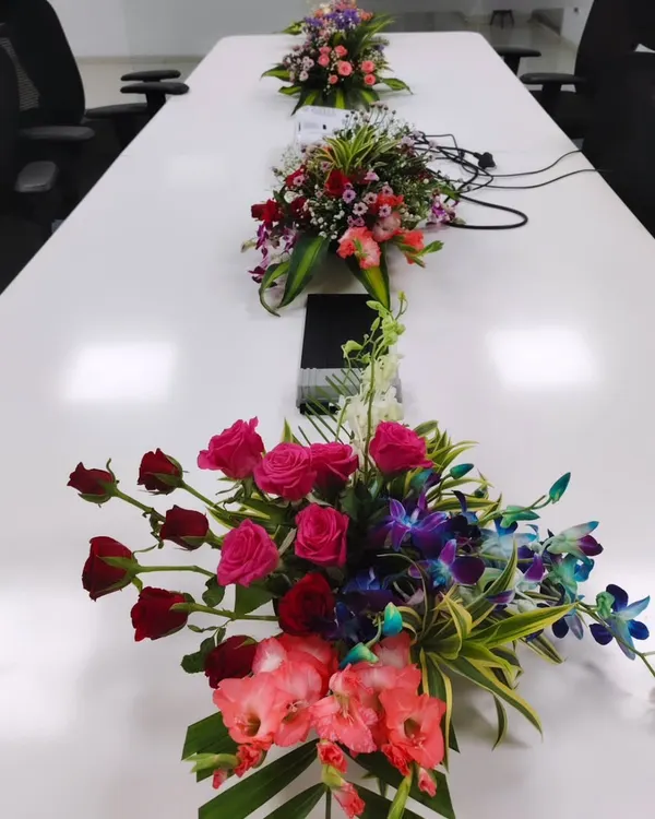 Even in a formal setting like a conference room, details matter. I provide custom floral centerpieces like these, designed to add color and life to the table without obstructing views during meetings.
