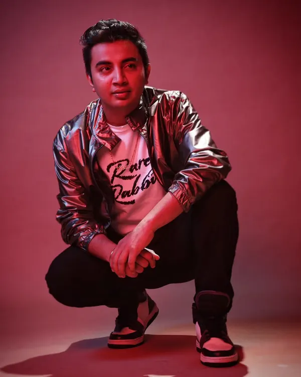 A posed shot from a professional photoshoot. This represents the modern, stylish, and confident brand I bring to every performance.