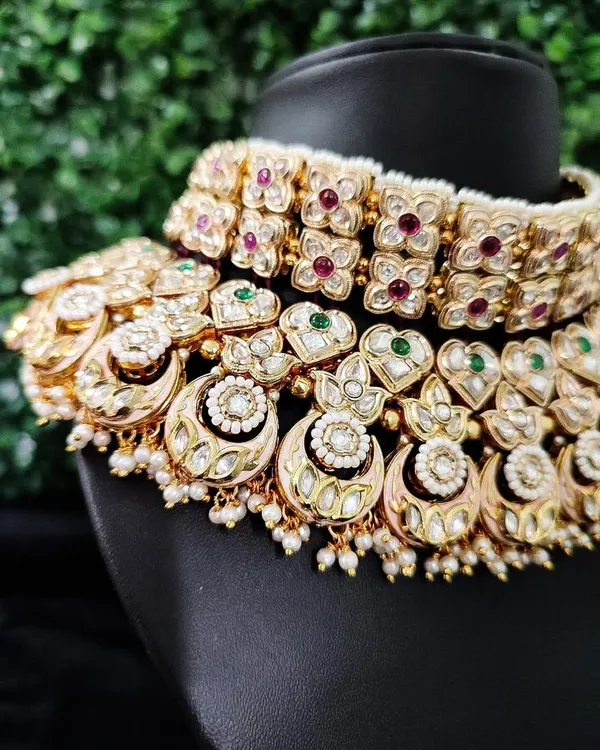 A detailed close-up of a traditional kundan bridal choker, showing the fine arrangement of stones and pearls.