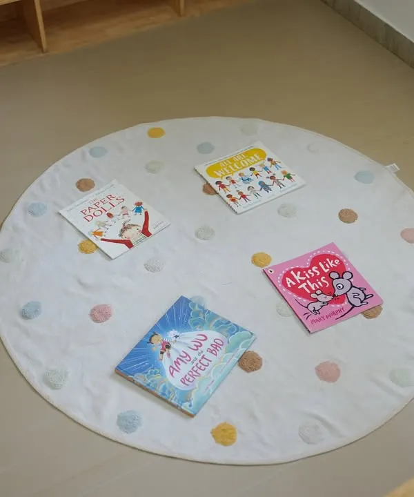 Our reading nook is a cozy and inviting space for children to relax with a book. I carefully select age-appropriate stories that are displayed on a soft mat, encouraging children to explore them independently.