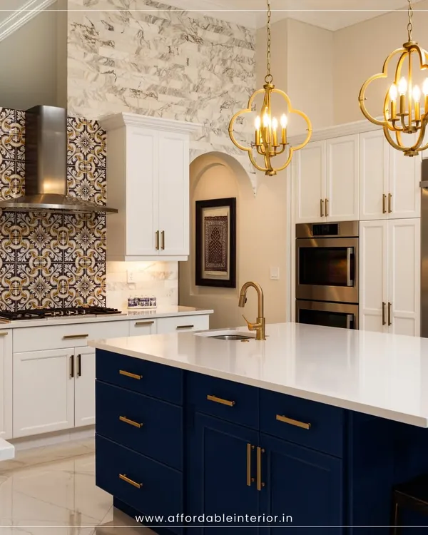 This luxurious kitchen design features a stunning blue island with white countertops, complemented by intricate backsplash tiles and elegant gold pendant lights.