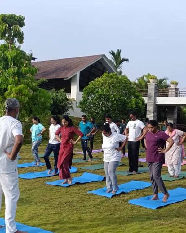 An outdoor yoga class in session, led by one of my experienced instructors. Practicing on the soft grass with the morning sun is a rejuvenating experience.