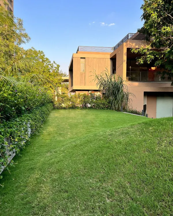 For the House of Terraces, I transformed a carport roof into this sloping green lawn. This design choice creates an elevated garden that blends seamlessly with its surroundings, offering a unique perspective and a private green space that feels both natural and intentional.
