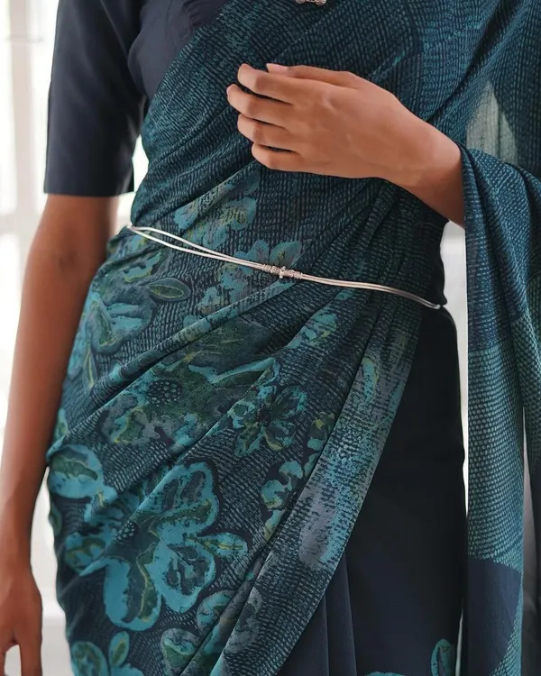 This is our hero item. The Nilā saree embodies our craft. It is a deep indigo silk georgette piece that took over 60 hours to create, combining intricate textures and custom-carved floral motifs using a specialized discharge printing technique.