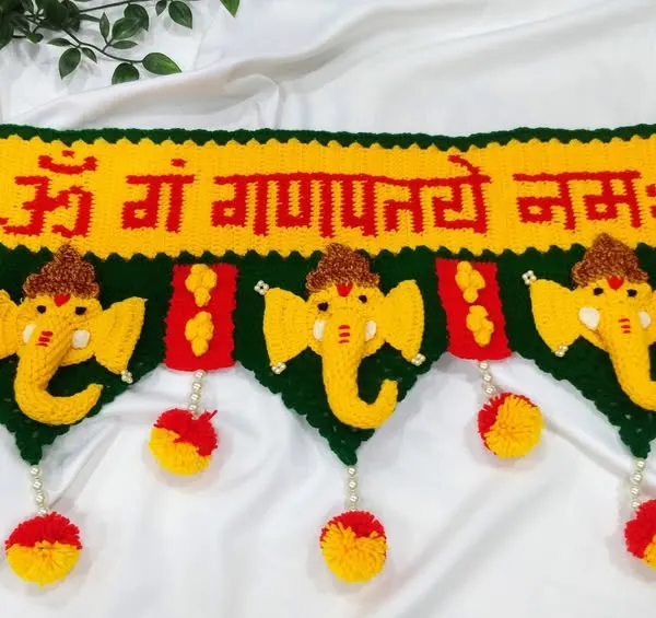 This is my most popular Ganpati toran, a design that brings blessings to your doorstep. I carefully crochet each element, from the "ॐ गं गणपतये नमः" text to the bright yellow Ganpati faces and colorful pom-poms, using durable 4-ply acrylic yarn.