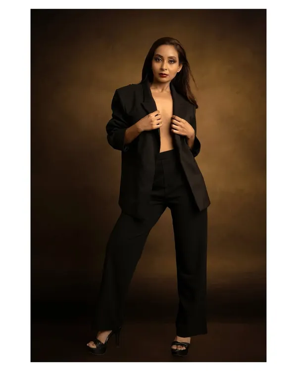 A powerful fashion statement with a classic power suit. I used a warm, painterly backdrop to contrast with the sharp, modern tailoring, creating a look suitable for a magazine editorial.