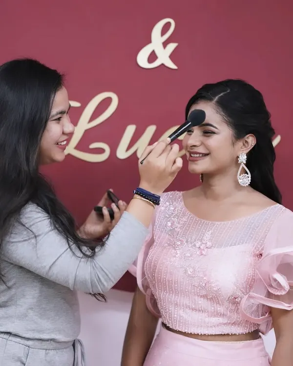 Behind the scenes of a creative shoot. This image shows me in my element, applying makeup to a model for a portfolio project.