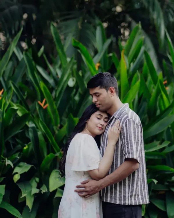 A peaceful embrace, surrounded by lush greenery. This is what it looks like to feel at home in someone's arms.