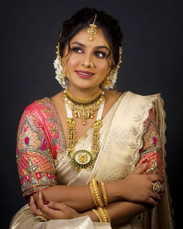 The art of South Indian bridal makeup. This look features a beautiful Kanjeevaram saree, temple jewellery, and a flawless makeup base with defined eyes.