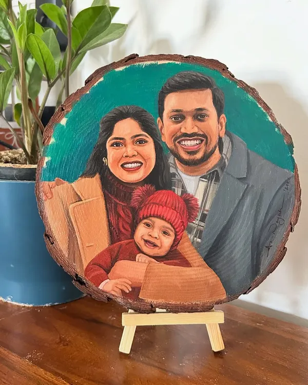 This sweet family portrait was painted on a large, round wood slice. The natural wood border frames the image beautifully, and the vibrant colors pop against the rustic surface.