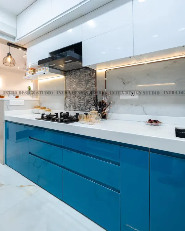 A close-up of the high-gloss blue acrylic drawers in our Delta 2 project. The handleless design and flawless finish contribute to the kitchen's ultra-modern and clean aesthetic.