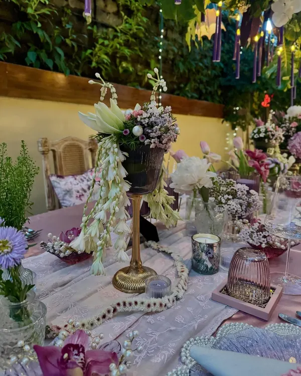 An exquisite and intimate sit-down birthday dinner I designed for Anushka Sharma. The tablescape features cascading white florals, delicate baby's breath, and a romantic color palette of lavender and pink, creating a truly magical setting.
