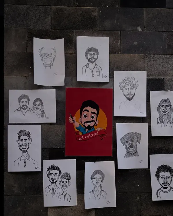 Here's a look at some of my work displayed on a wall. It shows the variety of faces I get to draw, from solo portraits and couples to even a cute puppy, all done in my signature hand drawn style.