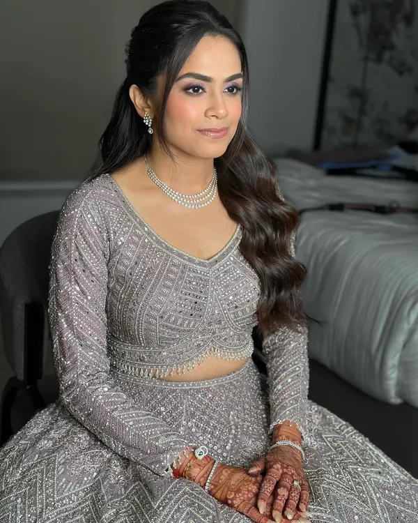 A flawless base kissed with the right glow, and eyes that shimmer with statement glam. This Sangeet look is all about confidence, elegance, and a touch of drama.