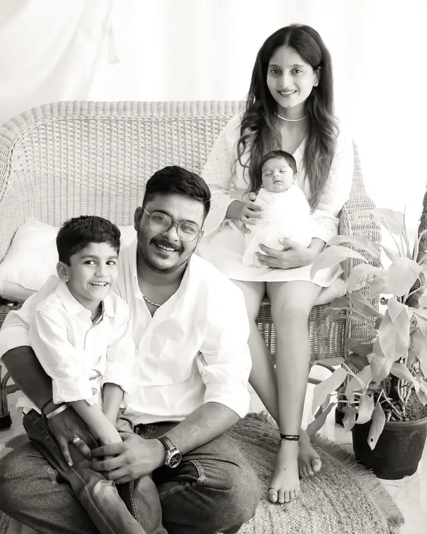 A beautiful black and white portrait of the complete family. We coordinate poses that feel natural and highlight the joy of having a new member in the family.