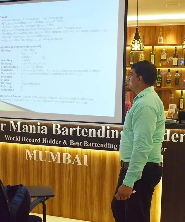 An instructor leads a theory class at our Mumbai academy. Our well-equipped classrooms and fully stocked bars provide the perfect learning environment.