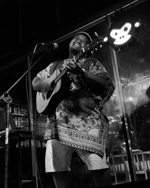 It's all about the feels. A black and white shot from an intimate acoustic gig, capturing the pure joy of just playing and singing.