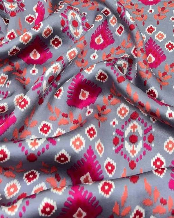 Sleek, soft, and sophisticated. This printed modal satin with a vibrant ikat-inspired design has a beautiful drape that's perfect for creating everything from a saree to a stylish co-ord set.