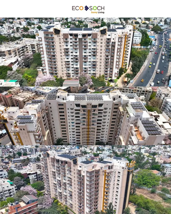 A multi-angle aerial view of a large residential building in Bengaluru, showcasing a comprehensive rooftop solar installation by EcoSoch Solar.