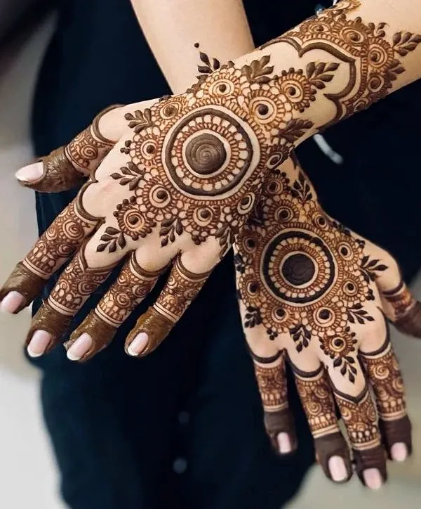 A bold and beautiful mandala design on the back of the hand. The dark center really makes the pattern stand out.