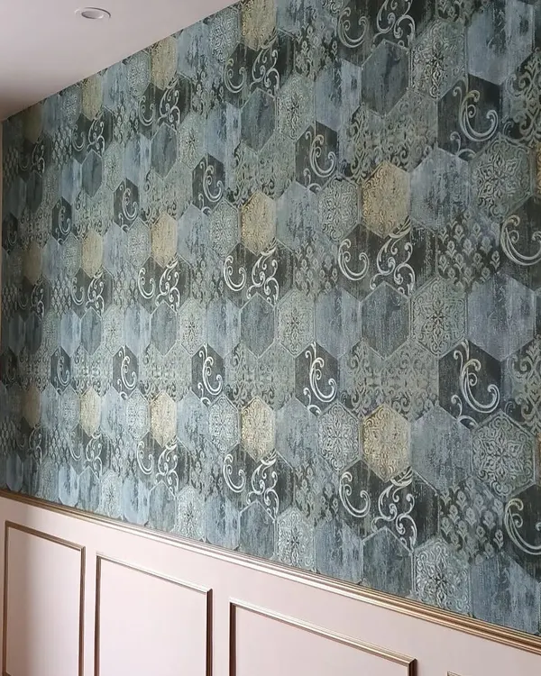 This is a client's home, transformed with a sophisticated geometric and damask wallpaper. The final result is an elegant accent wall that adds depth and character, perfectly complementing the room's wainscoting and creating a truly premium feel.
