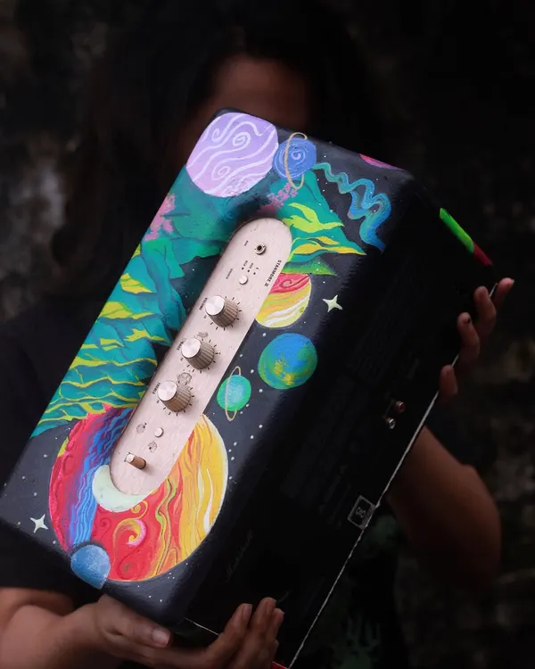 Here I am with the finished custom Marshall speaker. I painted a surreal, dreamy galaxy scene that wraps around the whole speaker. It's a functional piece of art that will definitely be a conversation starter.