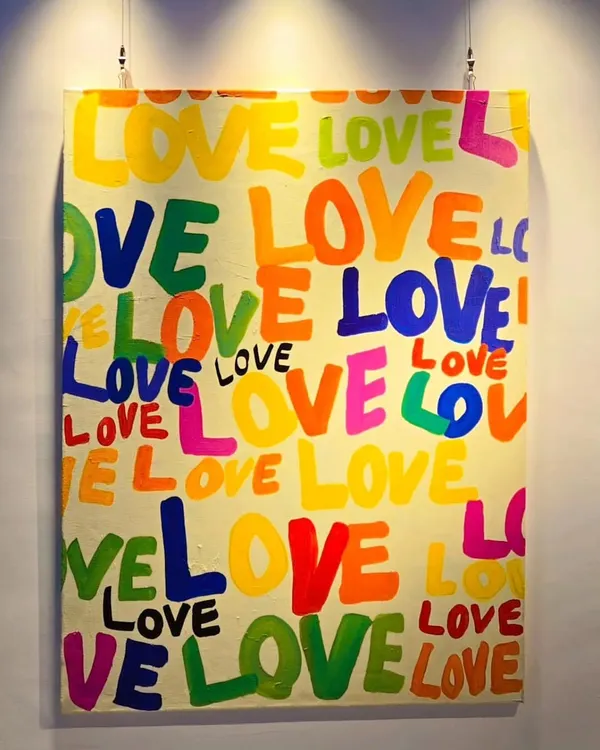 Spread the love with a hand-painted typography piece. This vibrant "LOVE" painting is a perfect gift or a cheerful addition to a bedroom, adding a pop of color and a positive message.