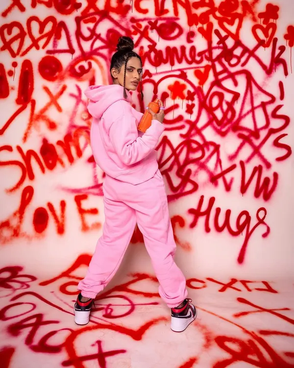 Rocking the pink power. This shot from our graffiti series combines a bold streetwear look with a custom-painted backdrop, creating a high-energy, urban-chic portrait that's perfect for a model's portfolio.