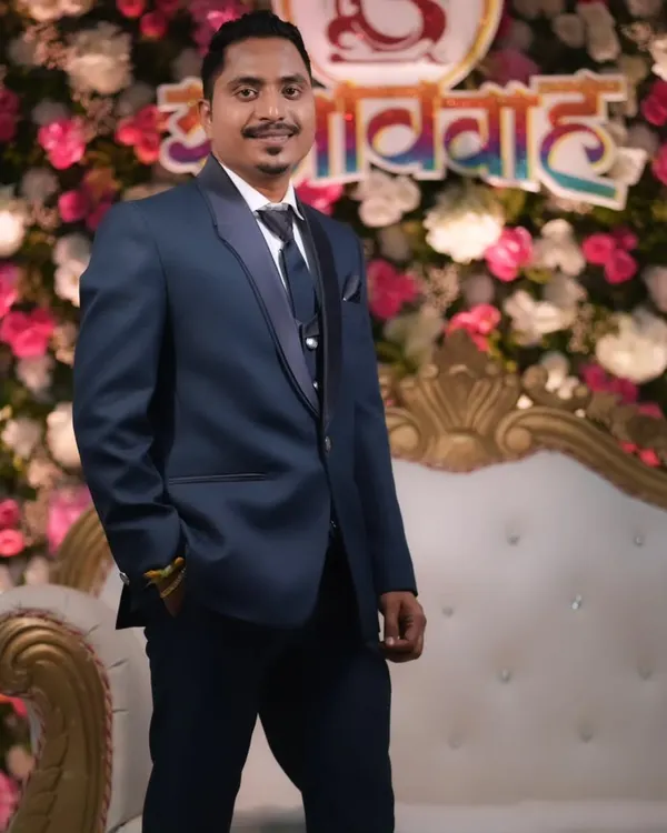 A dapper groom looking sharp in his reception suit. I provide subtle grooming and makeup to ensure the groom looks his absolute best and feels confident.