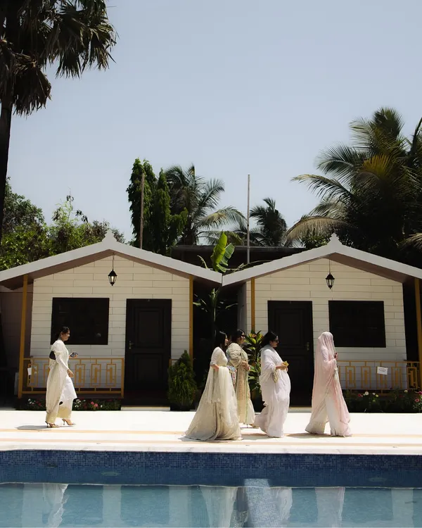 A wide shot of the venue for an intimate Nikaah, showing guests by the pool. This photo sets the scene for a relaxed and beautiful celebration.