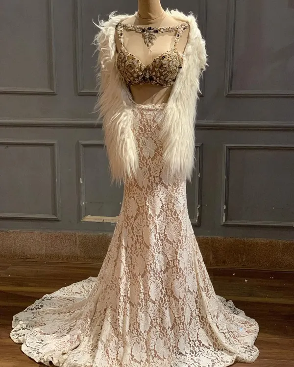 New in. This ivory lace lehenga with a heavily embellished bustier and a faux fur shrug is the definition of Indo-Western glam.