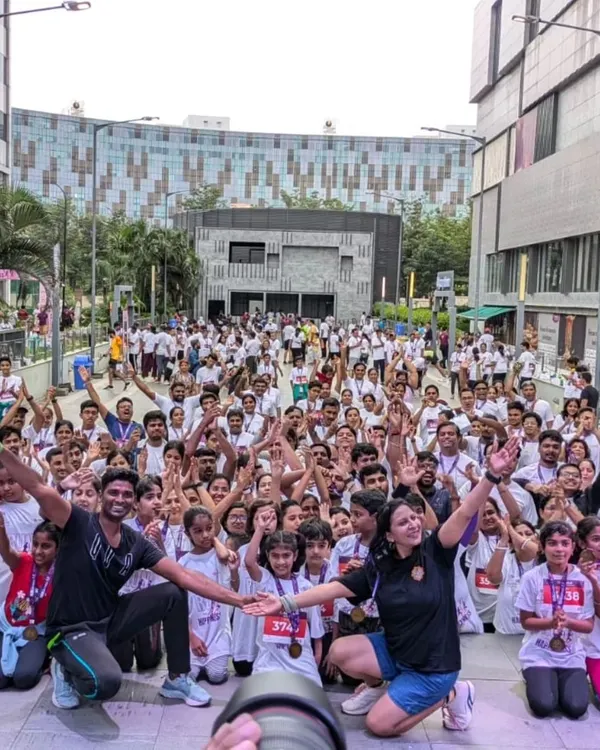 A sea of smiling faces and raised hands. This is the view from the stage at the "Run for Happiness" marathon, where we led a massive crowd in a pre-run Zumba warm-up session.