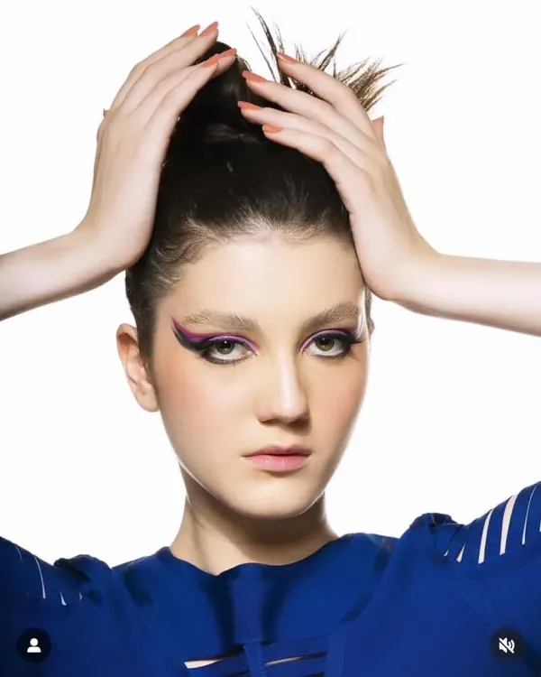 For this high-fashion beauty shoot, I created a sharp, purple graphic wing liner. The focus was on creating a clean, impactful look with flawless skin to make the eyes the central feature.