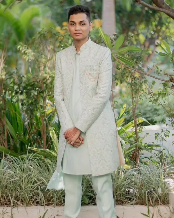 A light and airy outfit for a daytime event. This is a light pista-colored koul kurta with a matching open Indo-Western jacket featuring subtle embroidery, paired with pista pants.
