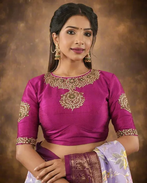 This magenta raw silk blouse is a showstopper, featuring heavy Zardosi and beadwork around the neckline and on the sleeves. It's the perfect ready-to-wear choice for a wedding or major festival.