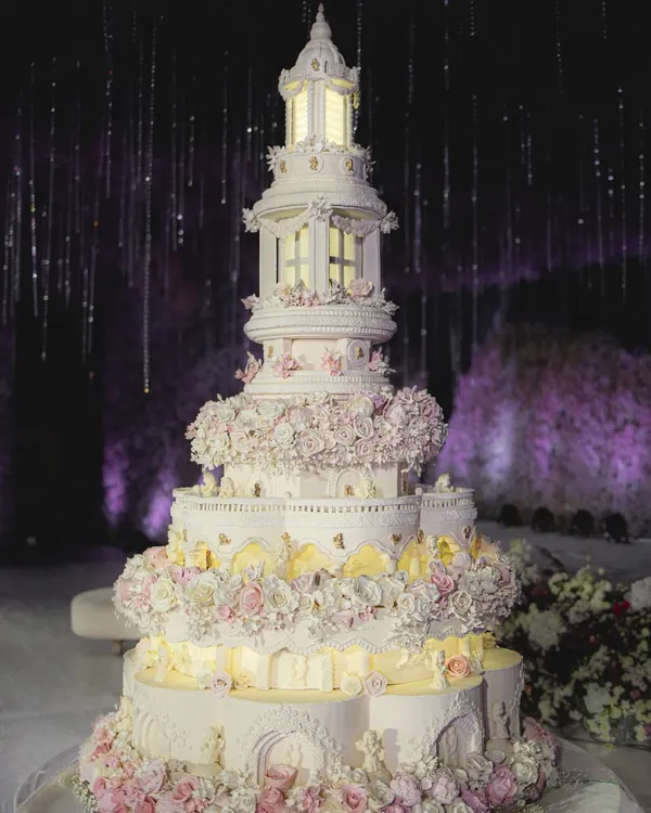This is one of my proudest creations, a majestic, multi-tiered wedding cake inspired by classic architecture. Standing over eight feet tall, it features intricate piping, hundreds of handcrafted sugar flowers, and internal lighting that brings it to life, making it a true centerpiece for a grand celebration.