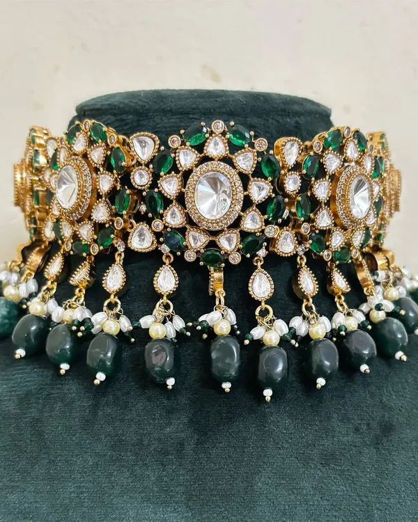 A beautiful bridal choker with green stones and American diamond accents. The dangling green beads add movement to this rental piece.