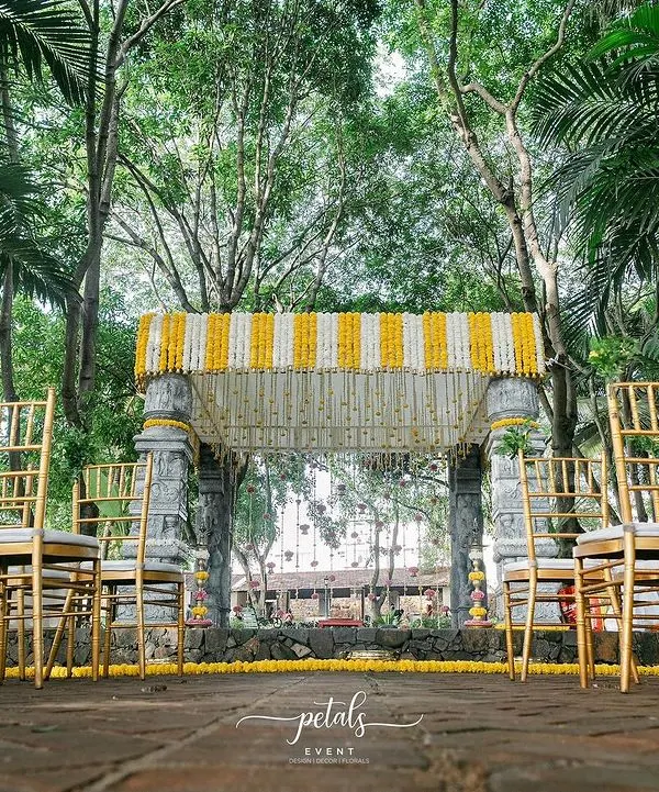 I transformed Angana the Courtyard into a temple of love with this stunning mandap. The stone pillars are adorned with vibrant marigolds and chrysanthemums, creating a timeless and elegant setting for the ceremony.