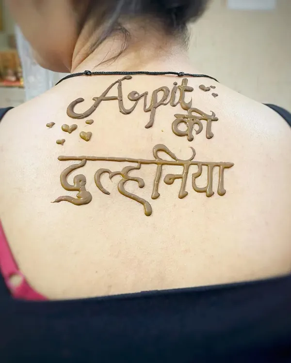 A fun and bold way to announce your new status. This "Arpit ki Dulhaniya" (Arpit's Bride) design on the back is a popular request for modern brides.
