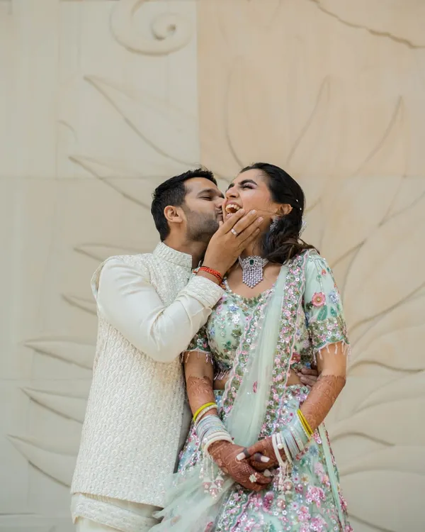 A playful and joyous moment from an engagement celebration. Capturing this spontaneous laughter is just as important as the formal ring exchange, as it shows the true happiness of the day.