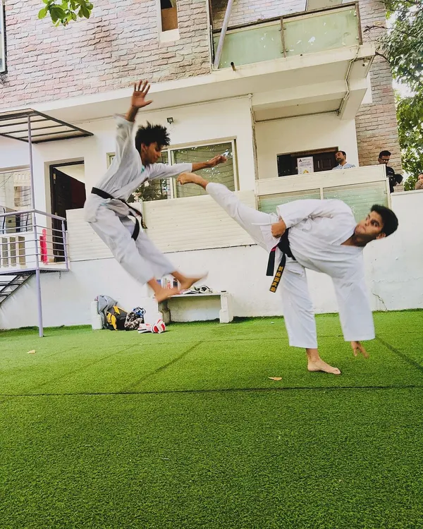 A demonstration of advanced kicking techniques, capturing the power and agility we develop in our senior students through dedicated martial arts training.