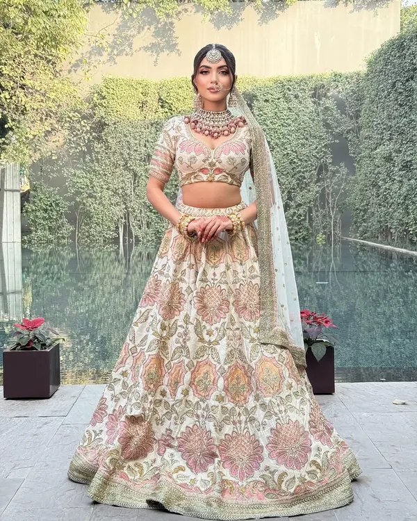 My process begins with understanding your vision. For this look, we chose a classic Sabyasachi floral lehenga, creating a vision of timeless elegance for a modern bride. The styling focuses on a cohesive look, from the perfectly pleated skirt to the selection of a statement polki necklace that complements the intricate embroidery.