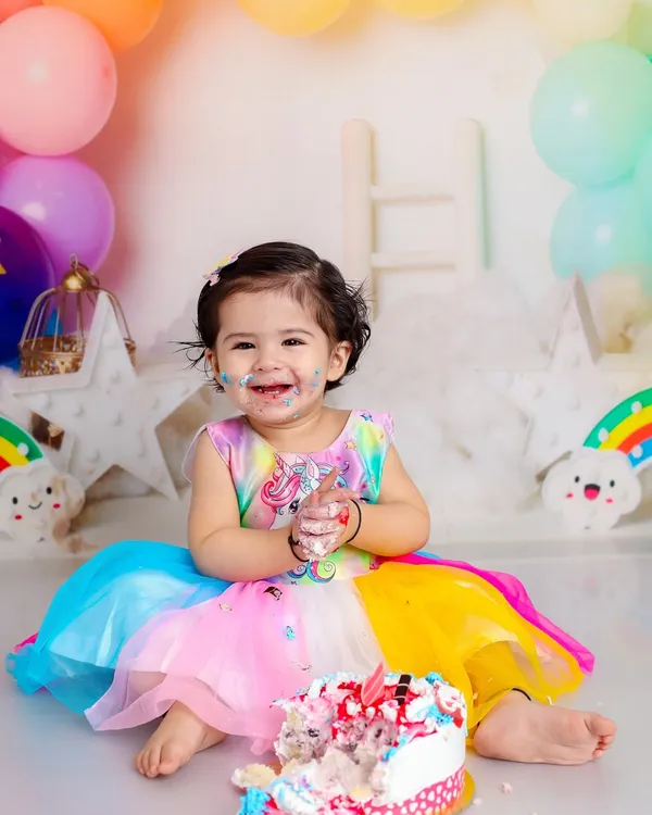 A first birthday is a whirlwind of color and joy, and nothing captures that better than a cake smash. This rainbow-themed setup with a delicious cake is all about celebrating one whole year of sweetness.