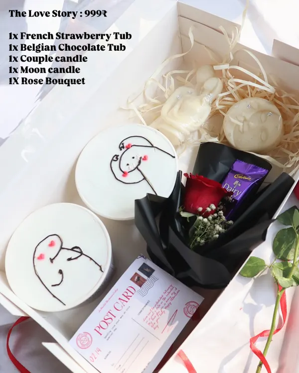 "The Love Story" hamper for Valentine's Day. It includes two dessert tubs with cute drawings, couple and moon-shaped candles, and a rose bouquet.
