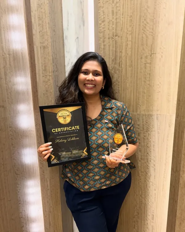 A proud moment holding my "Top 50 Mumbai Bakers" award and certificate. This recognition means so much and fuels my passion to keep baking and teaching.