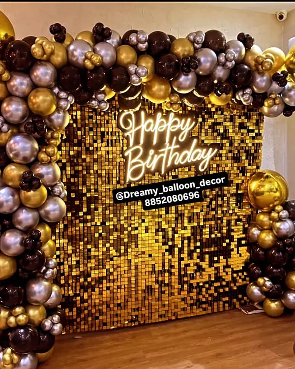This is the kind of statement backdrop I love to create for birthdays and big celebrations. The combination of a gold sequin wall, a modern neon sign, and a full arch of black, gold, and silver balloons creates a truly glamorous photo corner for any event.